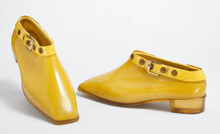 Pair of yellow PVC ankle boots with buckle around top