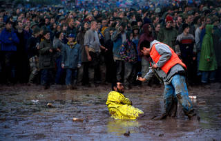 A festival-goer defeated by the mud