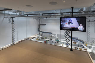 A glass panel wall overlooking a conservation studio two floors below