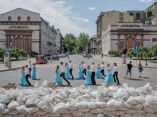 Young couples dancing behind a sandbag barricade